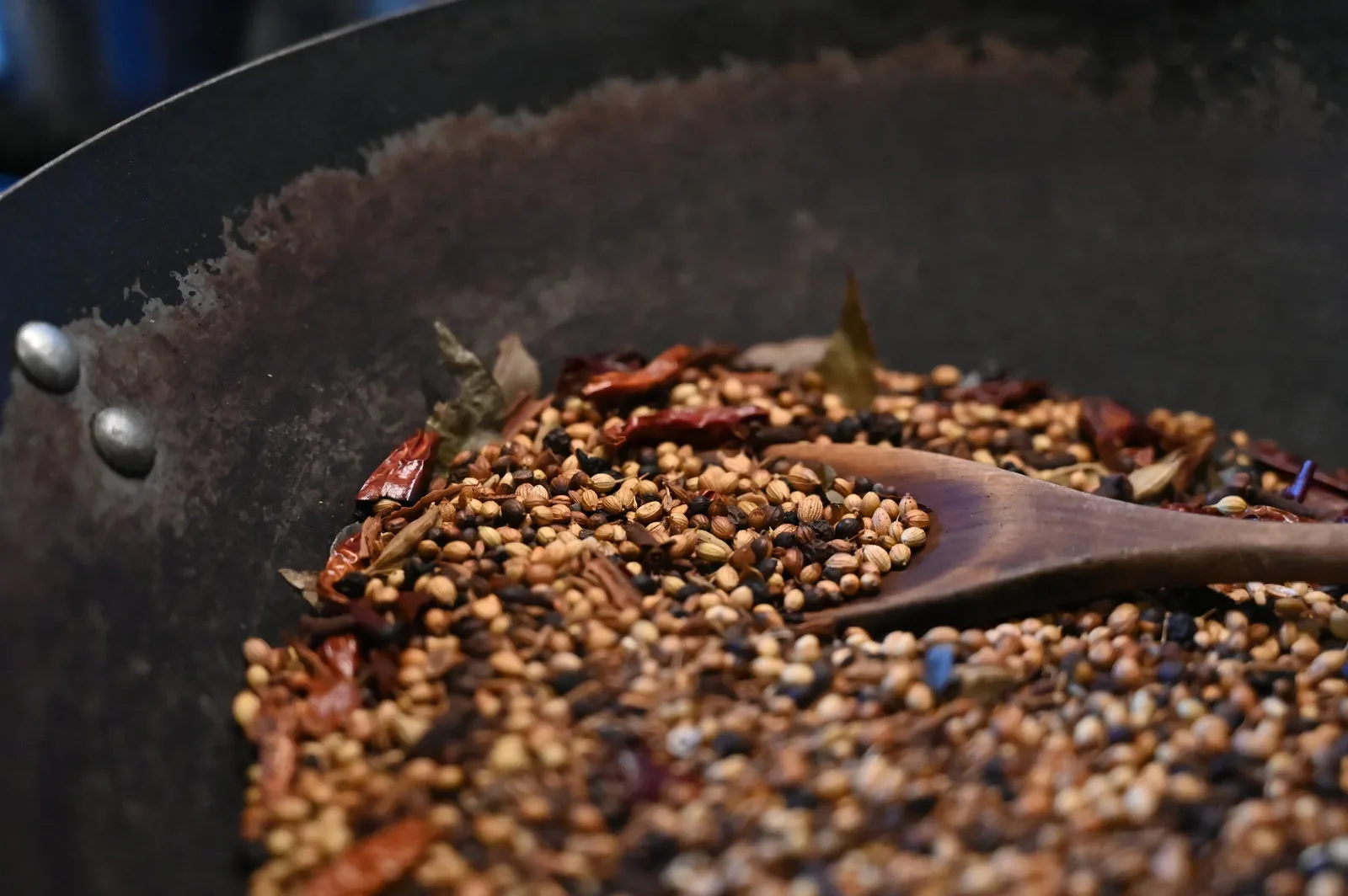 Close-up of whole coriander seeds and dried chillies