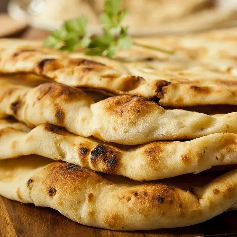 Freshly baked naan bread stacked and ready to serve